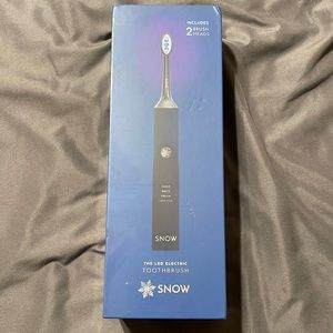 Snow electric toothbrush, unopened, sealed.